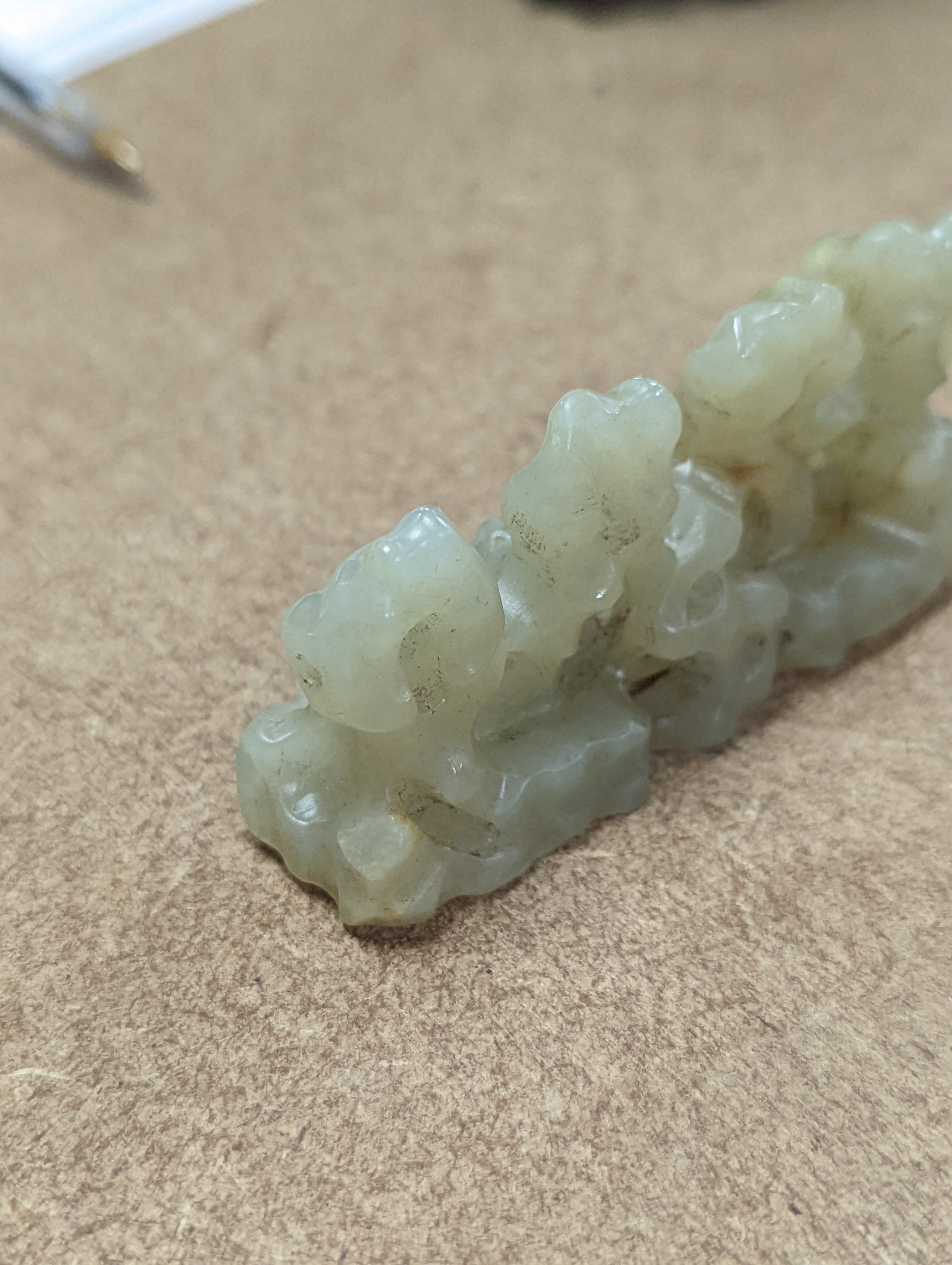 A Chinese celadon jade brush rest, 8cms wide